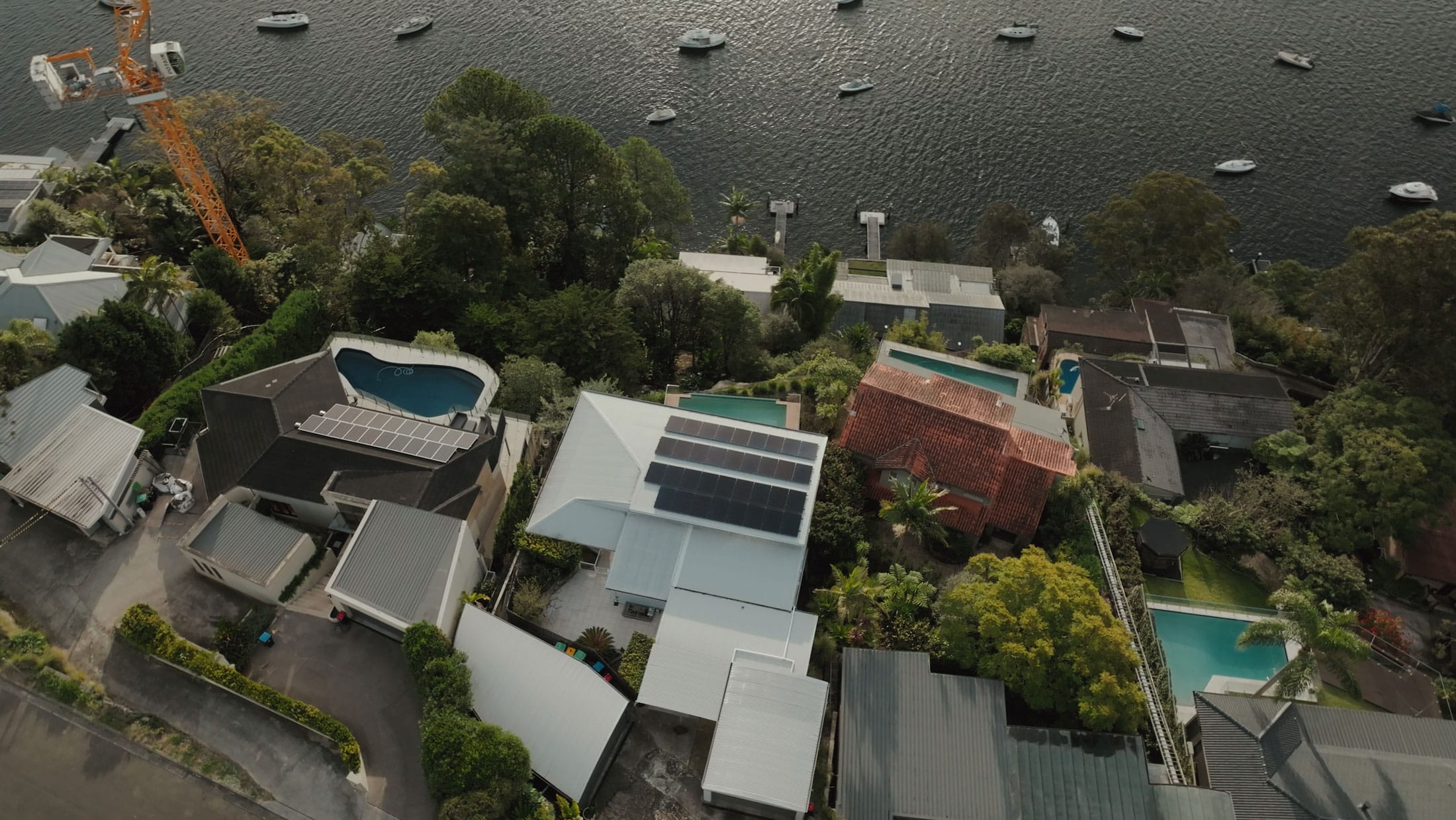 Aerial view of a coastal home with rooftop solar