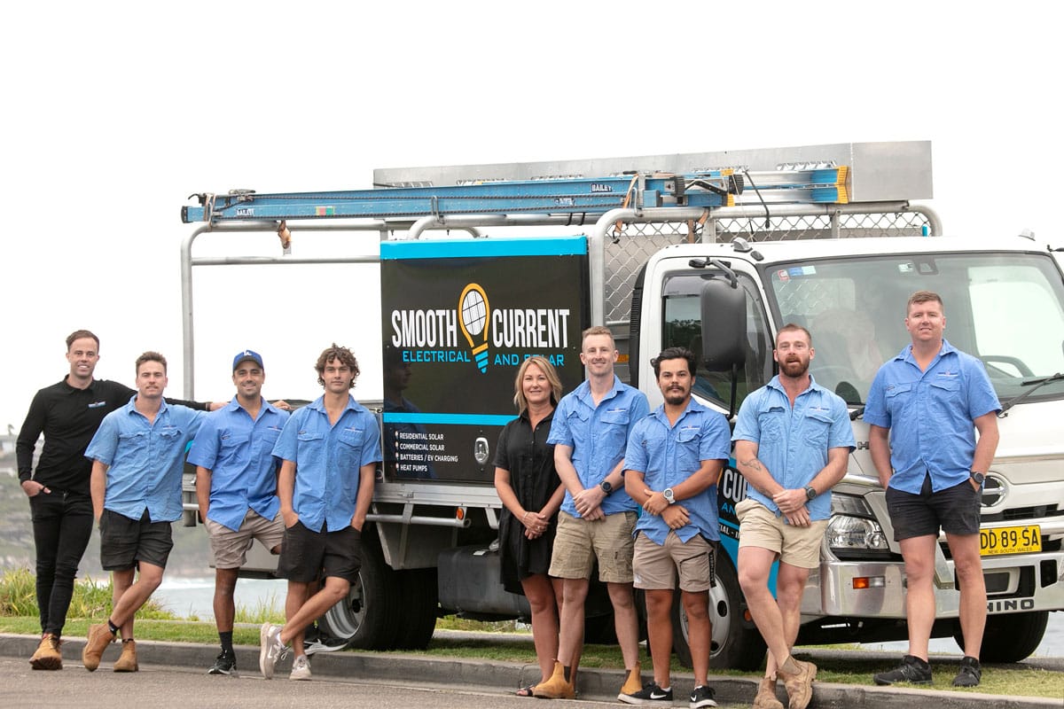 The SCE Solar team standing in front of their work vehicles