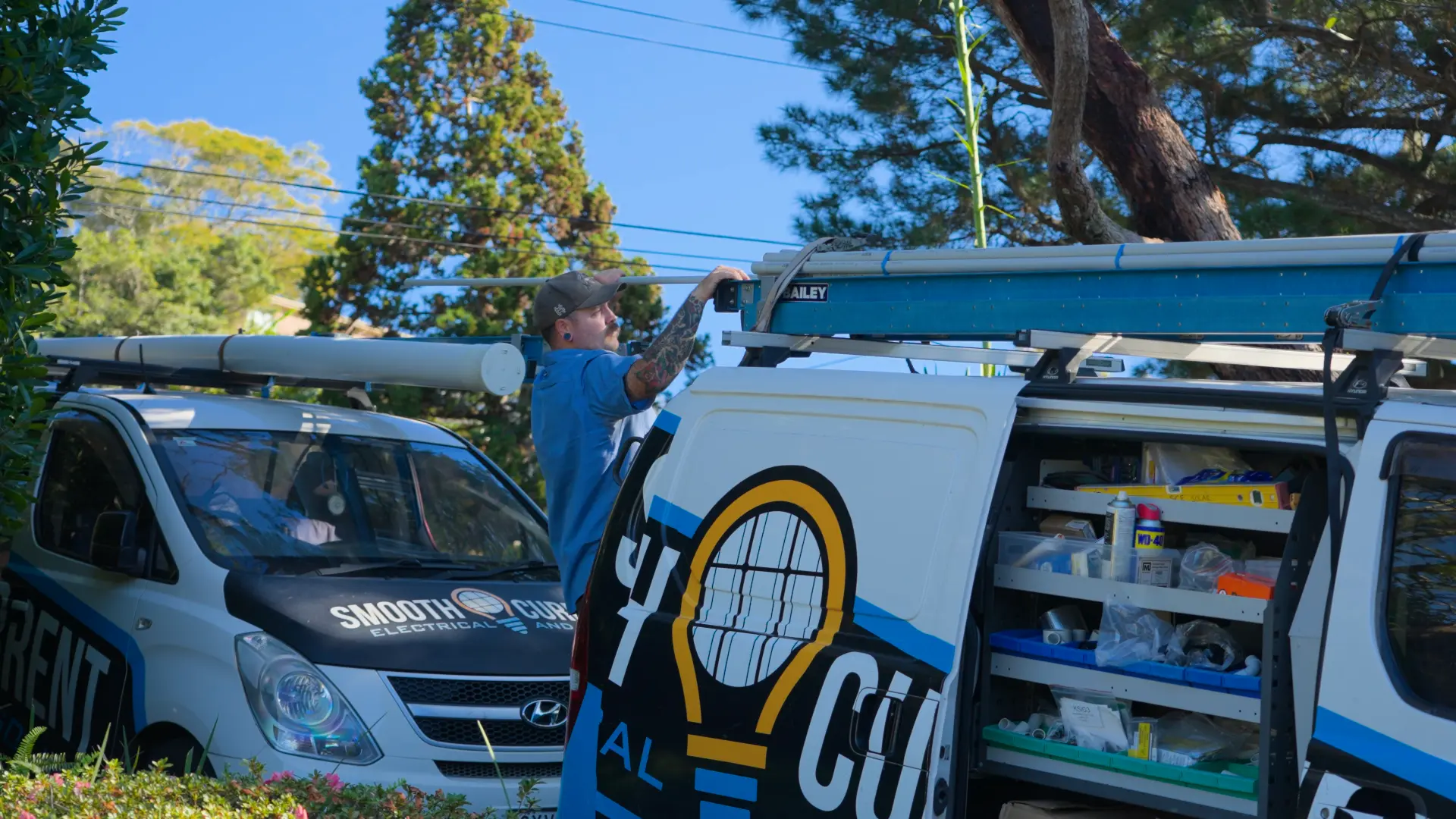 SCE electrician unloading conduit from the roof rack of a work van