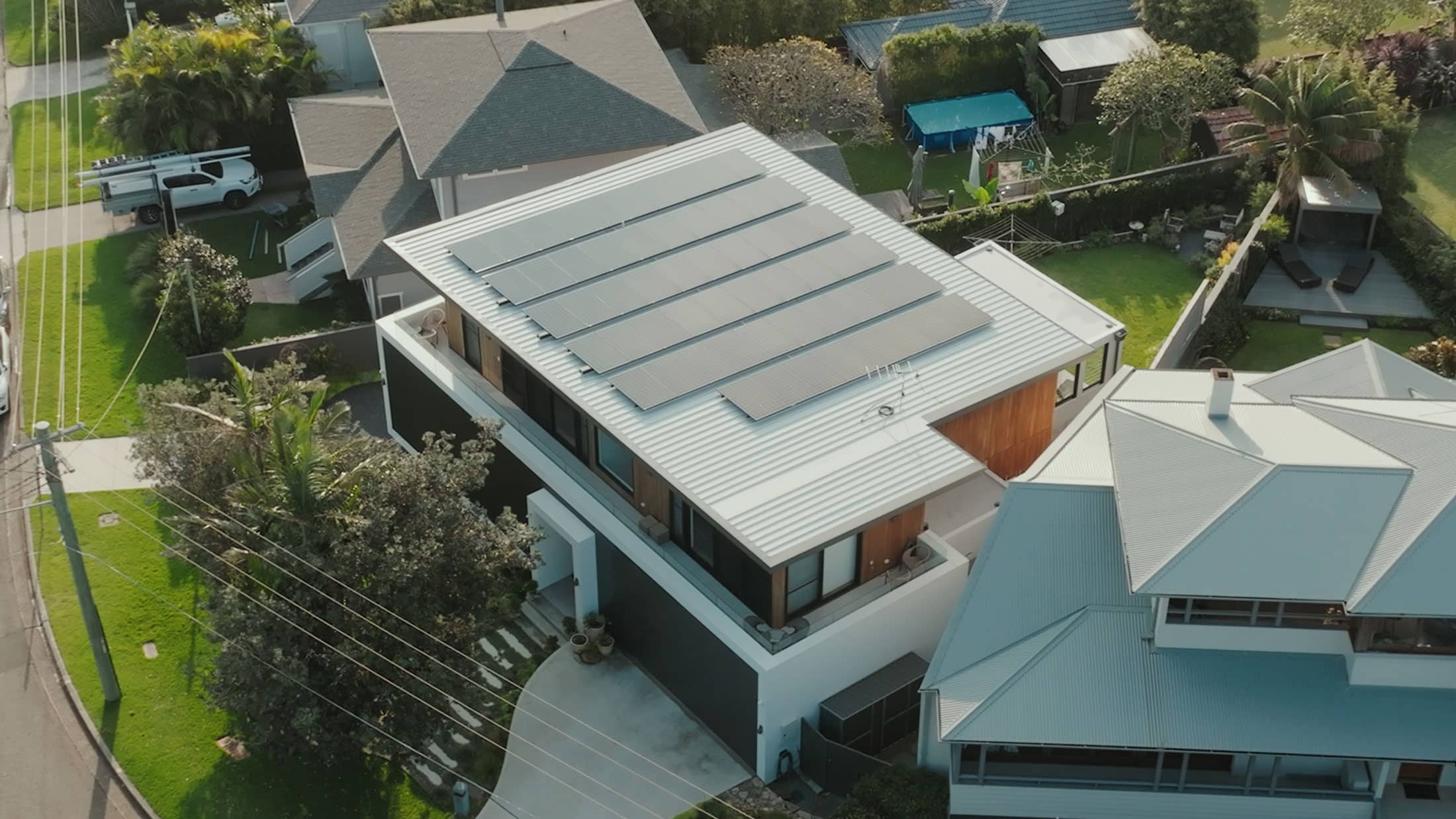 Drone view of a hillside home with solar panels