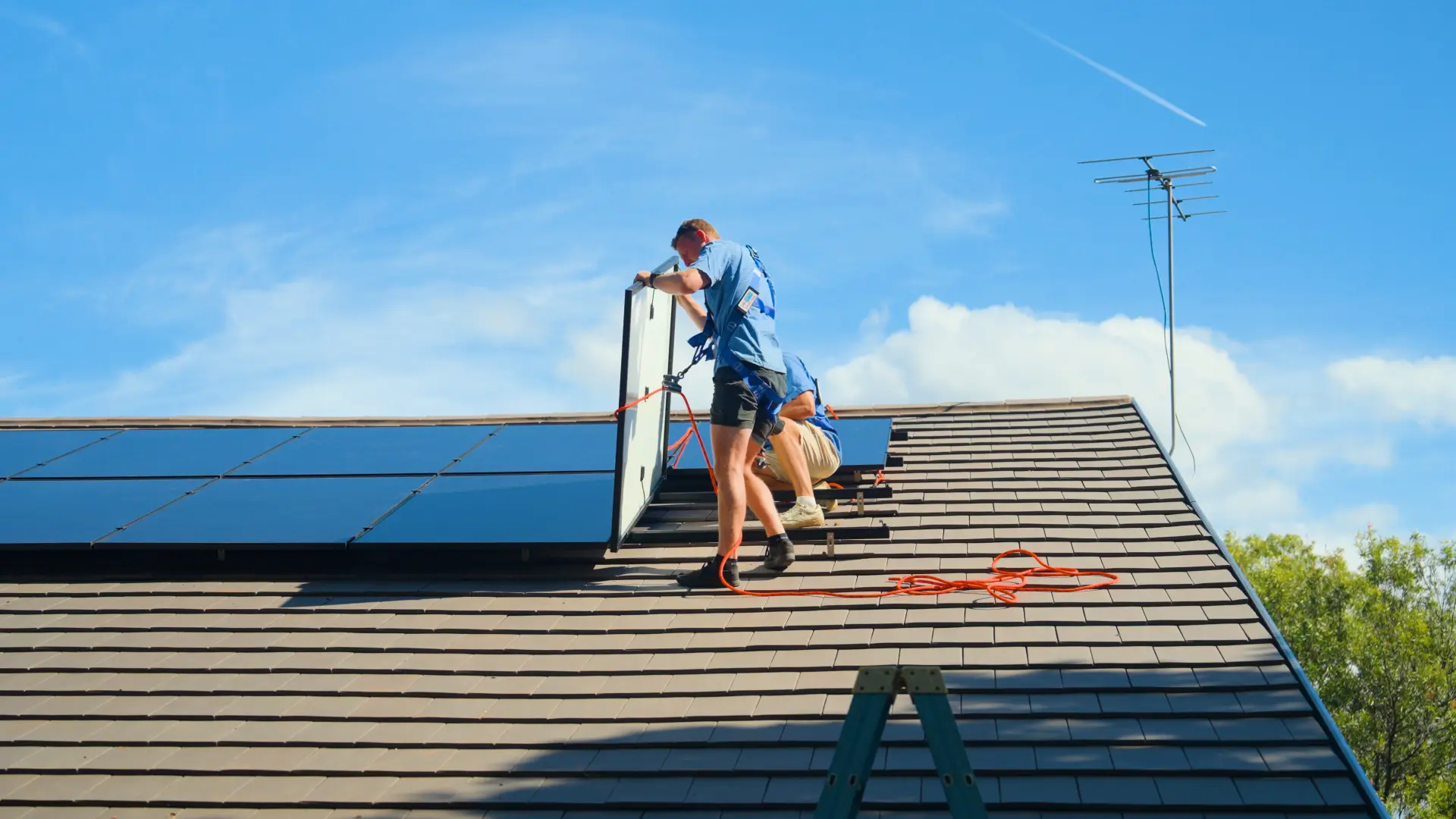 SCE installer fitting a solar panel to a tiled roof